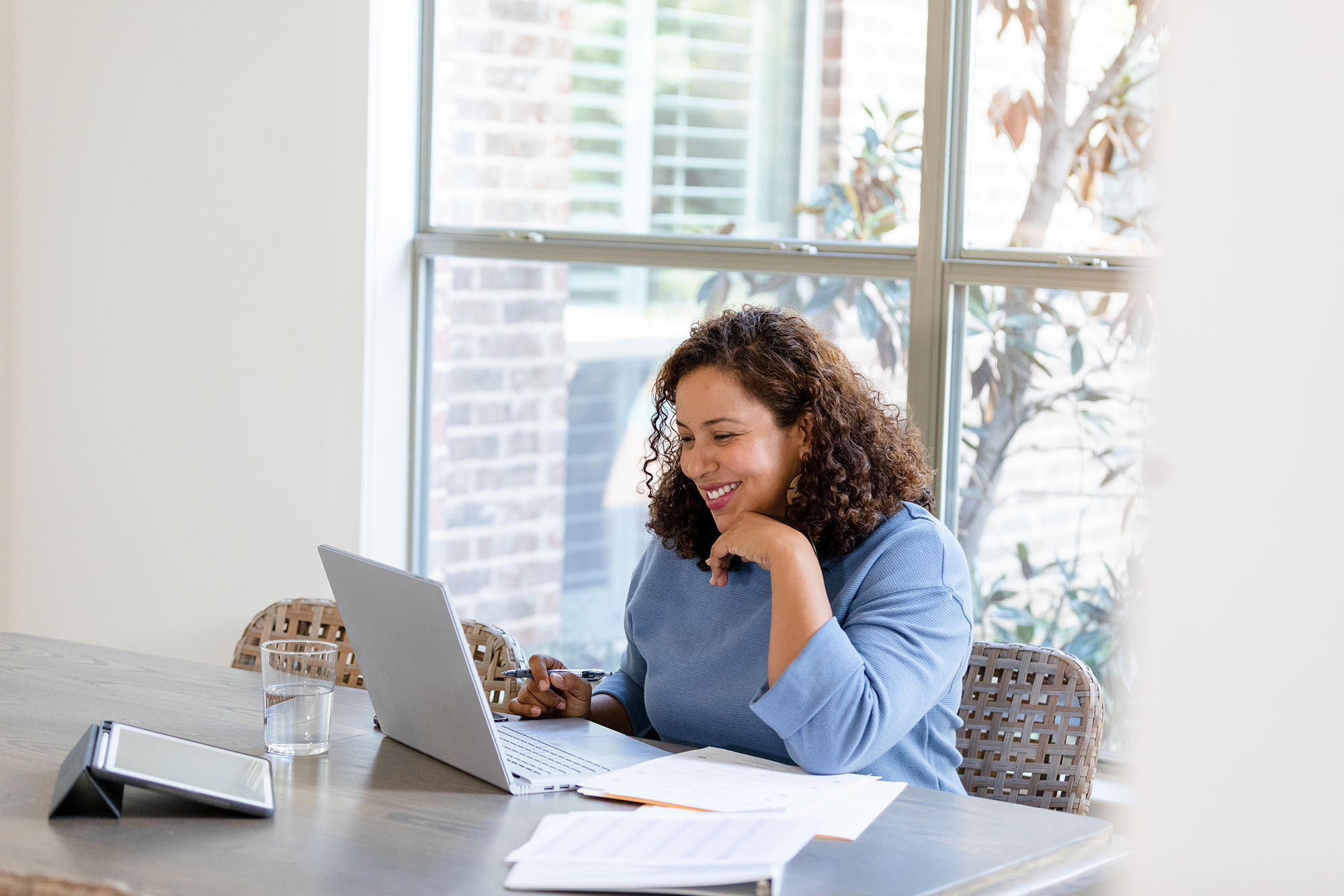 Woman smiling at her laptop