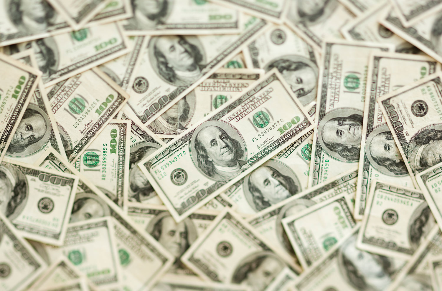 U.S. dollar bills scattered on desk